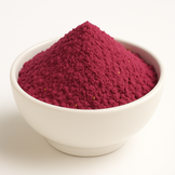 Red clumpy powder with very few seeds in a white bowl.