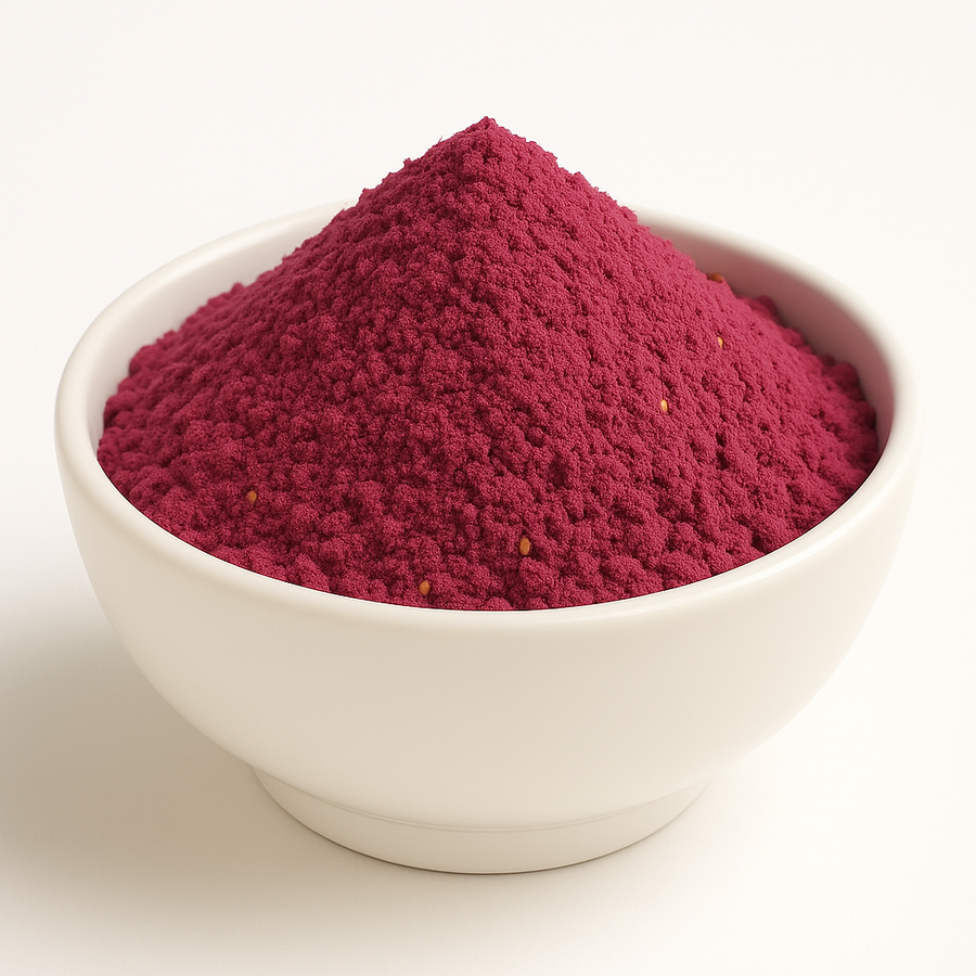 Red clumpy powder with very few seeds in a white bowl.