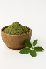 Brown, Greenish powder in a wooden bowl next to senna leaves.