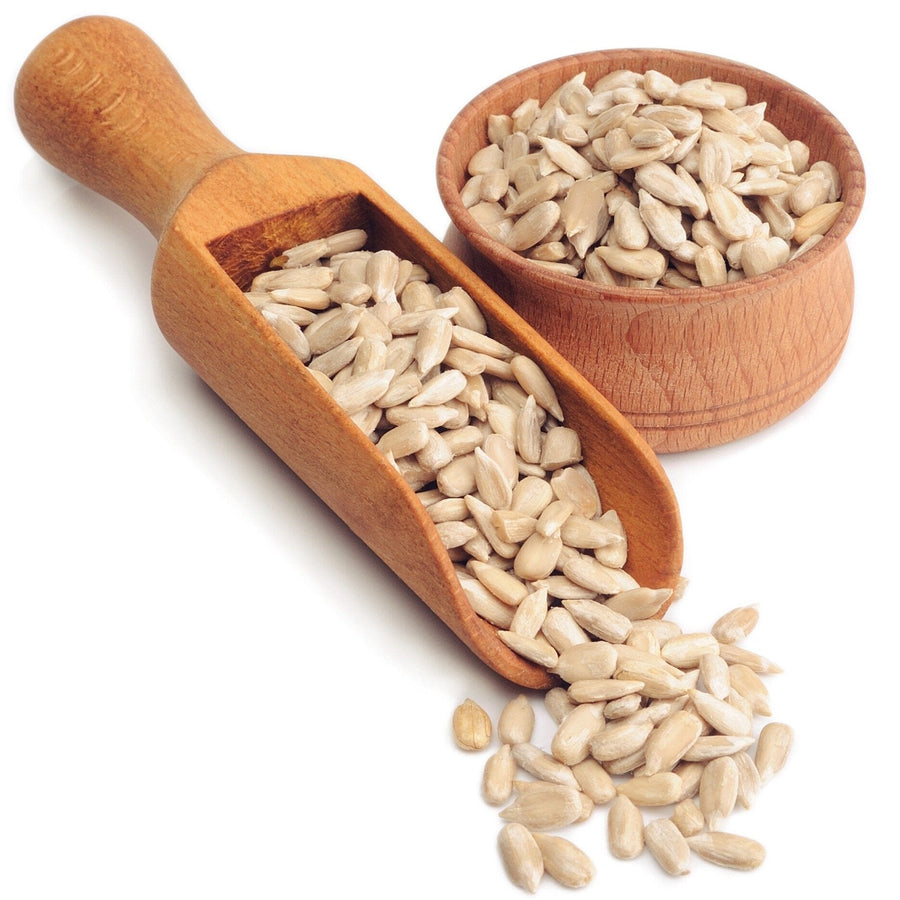 Image of bowl wooden bowl and serving spoon of Sunflower Seed Kernels on white background