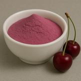 Red powder in a white bowl next to 2 cherries.