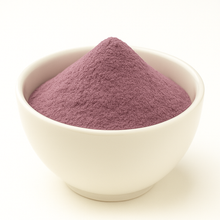 Purple color powder in a white bowl.