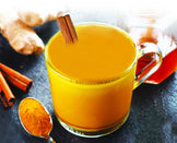 photo of glass cup of Turmeric Bone Broth with cinnamon stick 