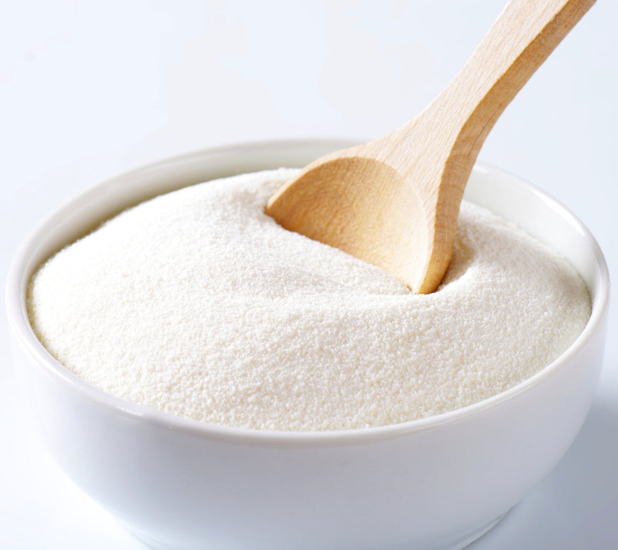 Whole Milk Powder  win white bowl with wooden spoon