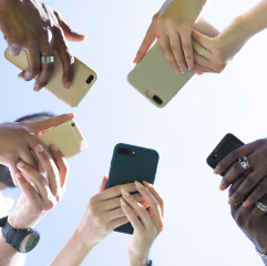 Image of a group of people holding a phones 